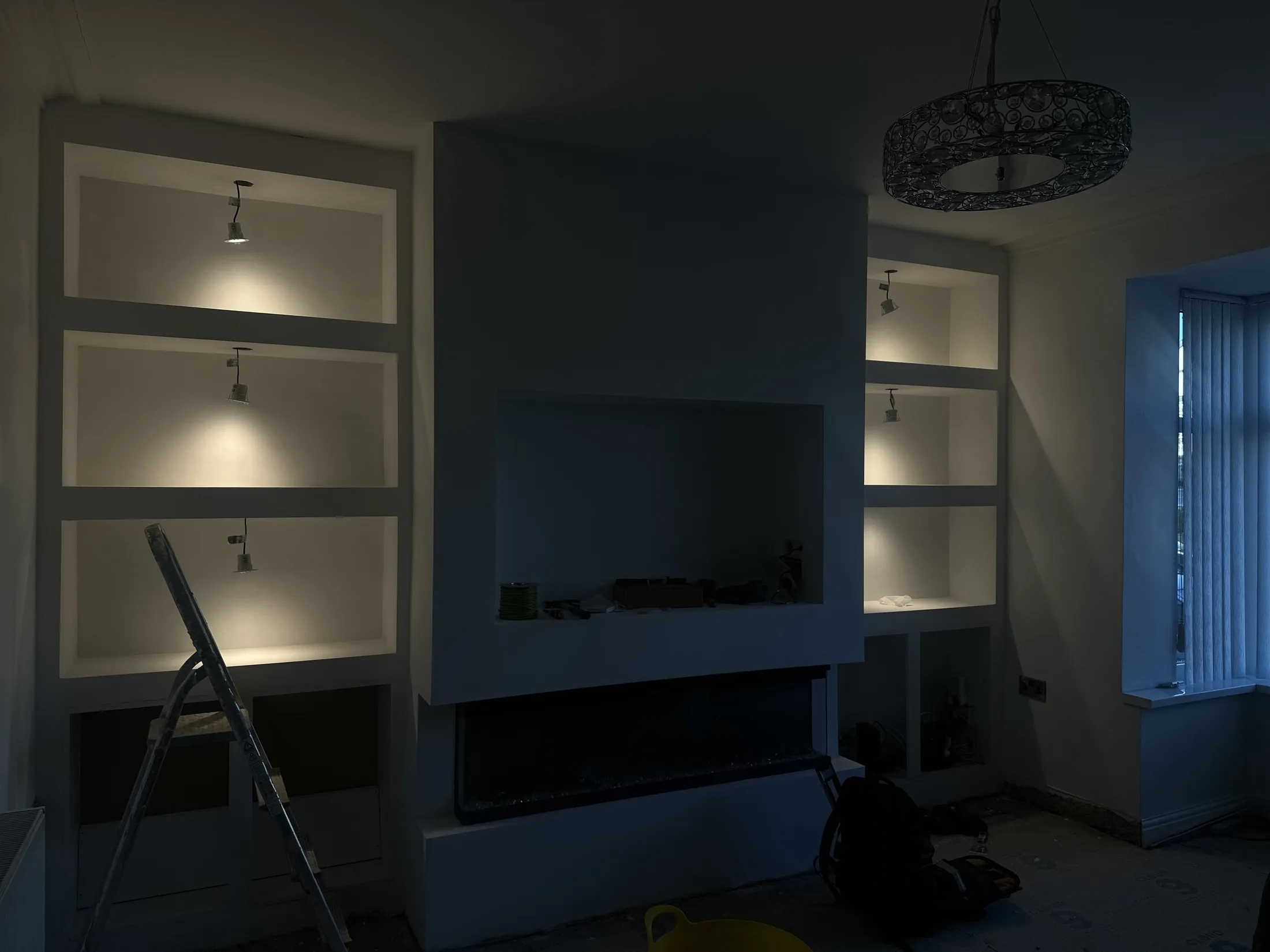 Lit display niches around a feature wall during interior work